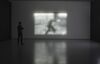 A screen made out of lights from Jim Campbell's exhibition. The shadow of a man walking can be seen on the pattern.