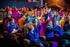 school group raising their hands in DCA cinema seats