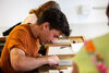 People doing lino cutting around a table in DCA Print Studio