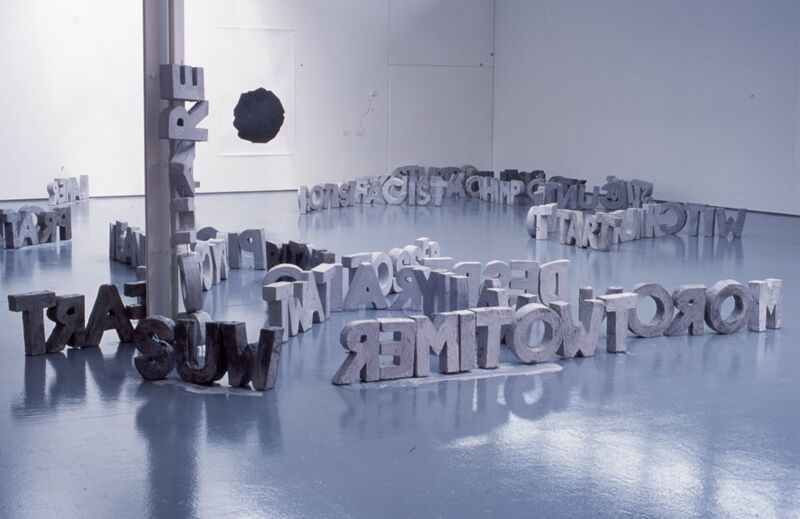 Words sit on DCA Gallery floors, made out of grey cement.