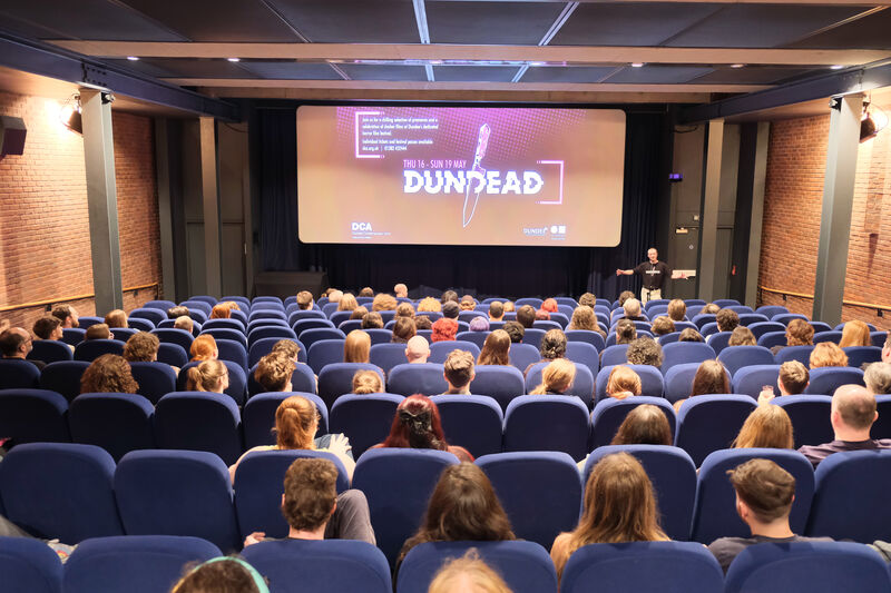 Michael Coull giving an introduction to an audience in DCA Cinema in front of a Dundead screenslide