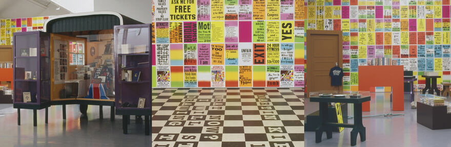 A selection of images from Allen Ruppersberg's exhibition at DCA. The floors are black-and-white check, and there are bright, multicoloured graphic posters all over the walls with different slogan and sentences on them.