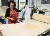 Zineb Sidera uncovering an print on a printing press
