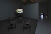 Margaret Salmon's exhibition. 4 chairs face a television with a black-and-white close-up image of two nude bodies on it.