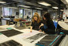 Artist Sukaina Kubba and Head of DCA Print Studio Marion Ferguson in DCA Print Studio looking at samples